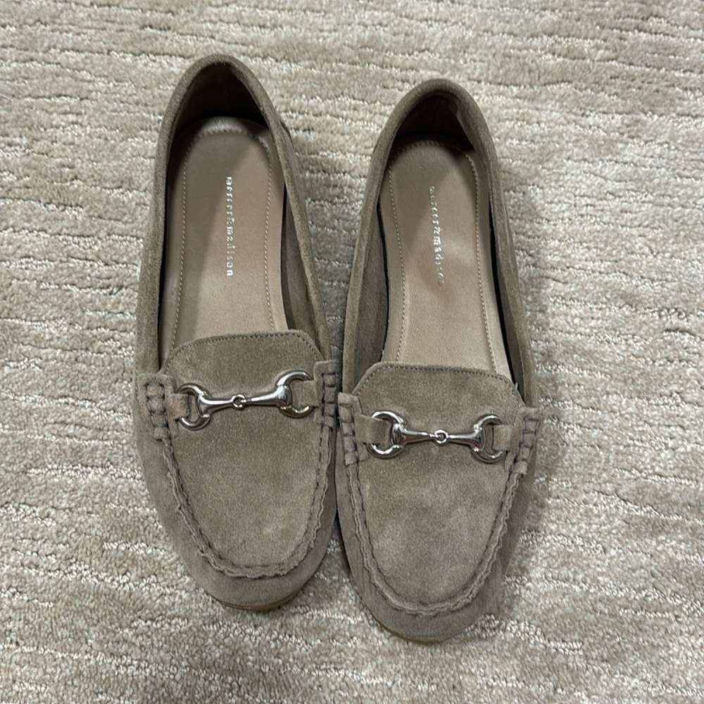 Grey suede flats with silver buckle.